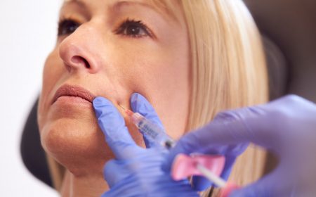 Close Up Of Mature Woman Sitting In Chair Being Give Botox Injection By Female Doctor